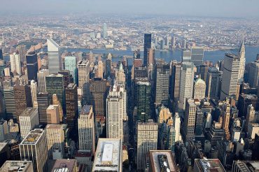 Office and residential buildings, including the Chrysler Building, right, stand in midtown Manhattan in this aerial photograph taken over New York, U.S., on Wednesday, July 7, 2010. Photographer: Daniel Acker/Bloomberg